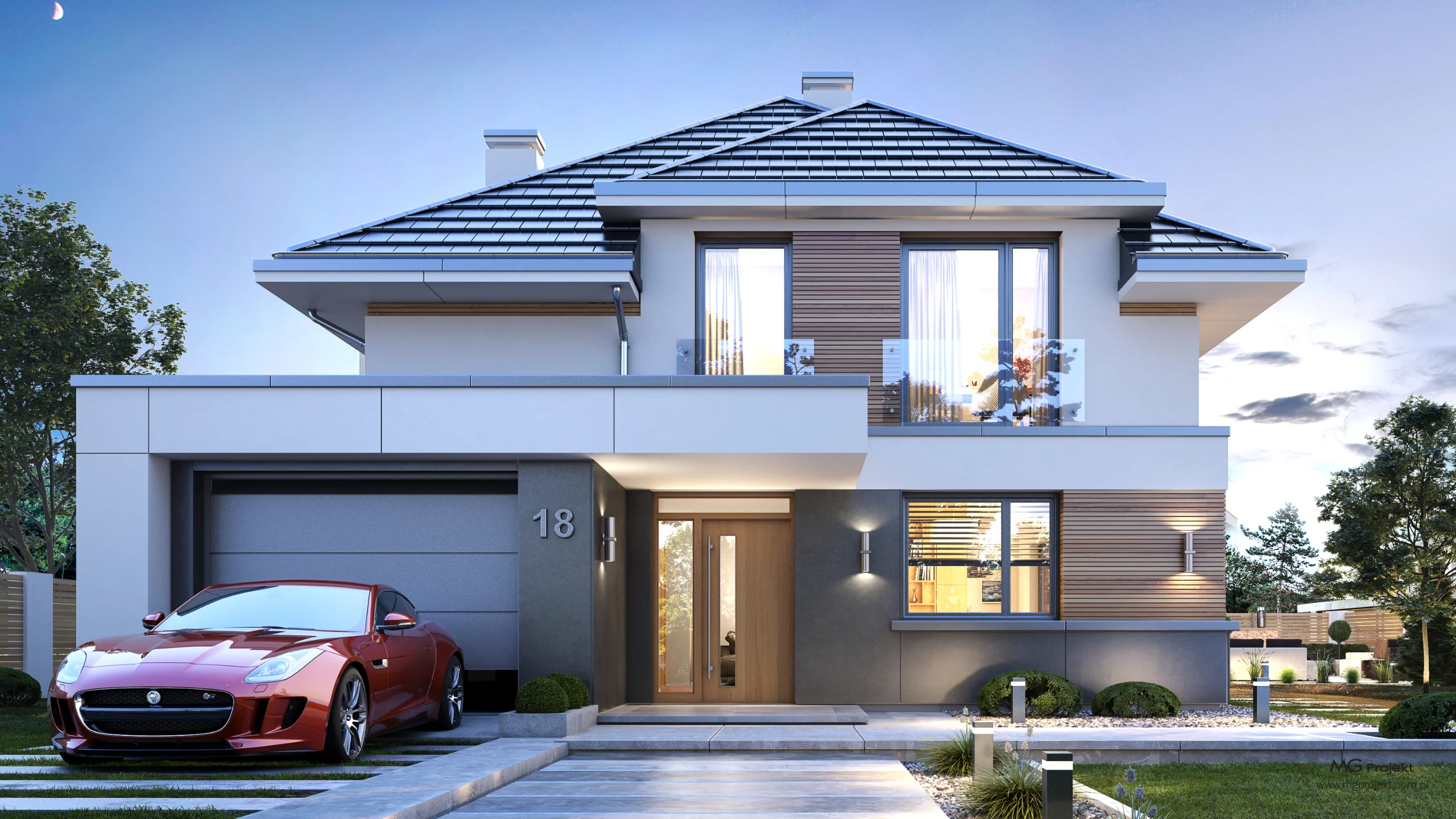 Budynek Domy Akacjowa widoczny z zewnątrz od strony drzwi wejściowych w nocy.